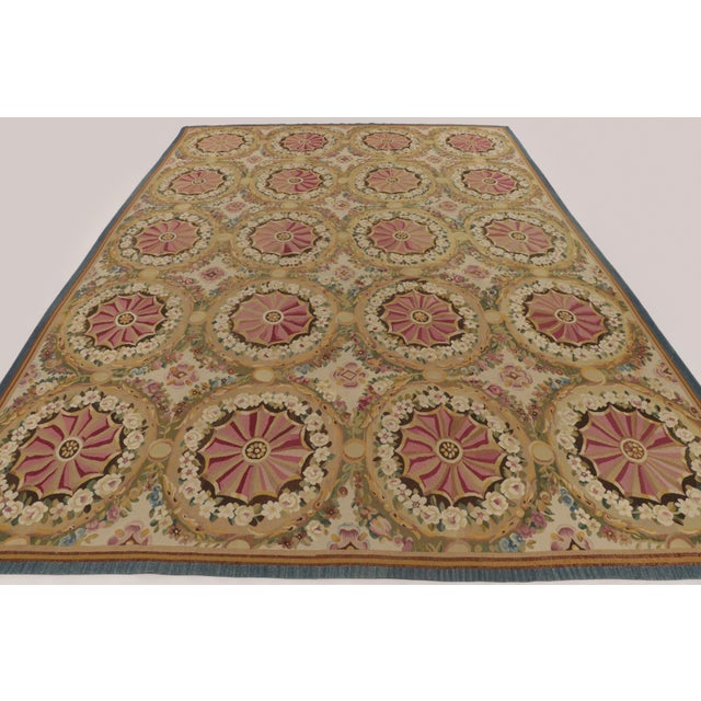 Handwoven in wool originating circa 1950-1959, this 12x17 oversized vintage French Aubusson rug features a repeating...