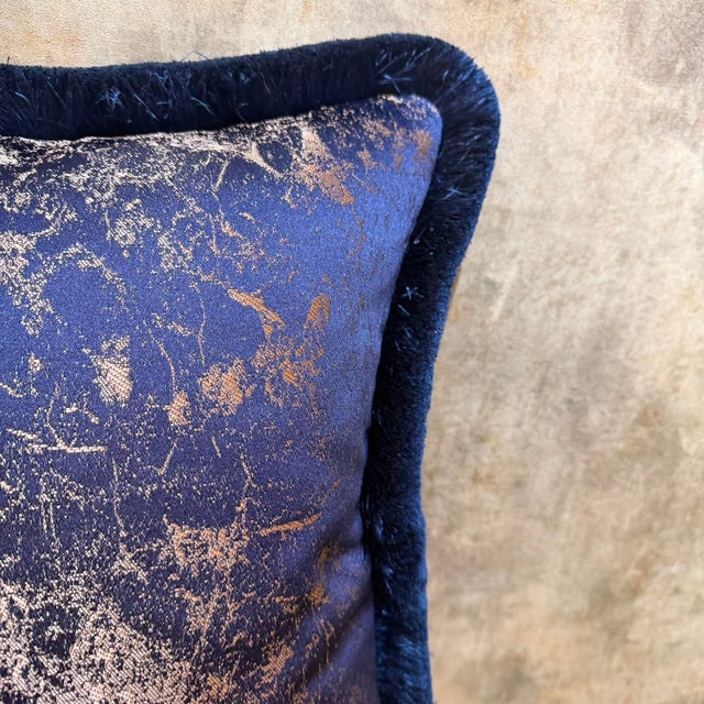 The handmade cover uses a deep navy ground with abstract gold metallic thread woven throughout, and the edge carries a...