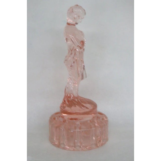 This gorgeous flower frog vase is made of glass. This lovely piece has a beautiful silhouette, it is made of pink glass...