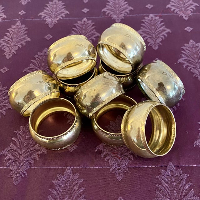 A lovely set of gold tone brass napkin rings with a light vintage patina. The ring openings are approximately 1.5” W.