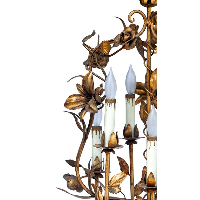 A Charming Antique Italian Tole Gold Painted Chandelier with six lights and original candlelight covers. Comes on metal...