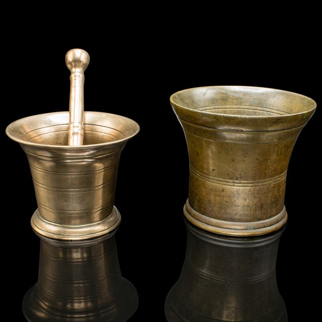 This is a duo of antique mortars with pestle. An English, bronze apothecary aid, dating to the early Georgian period,...