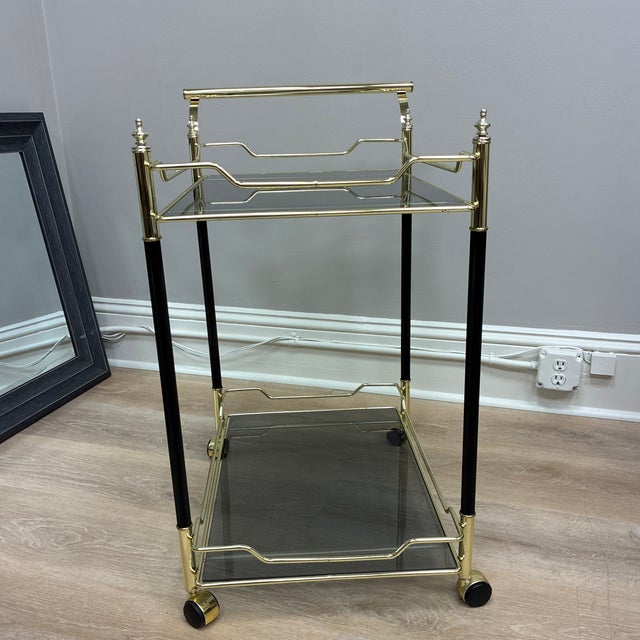 This sophisticated late- 20th- century drink trolley exemplifies contemporary Italian elegance. The design features black...