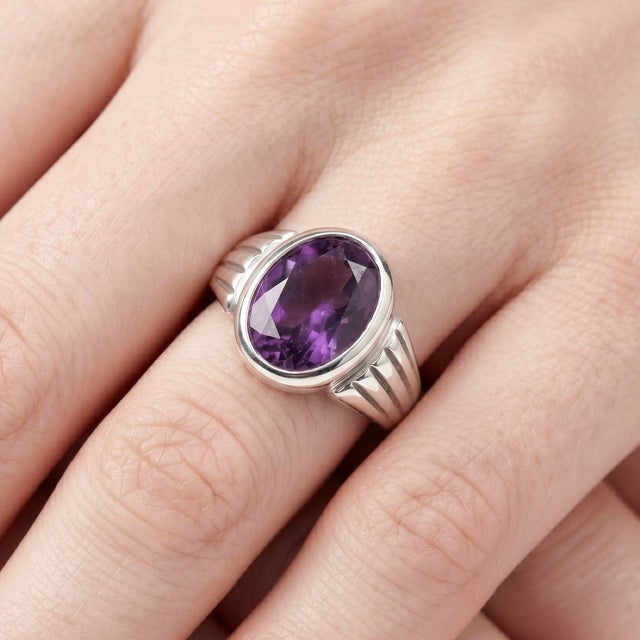 Bold, refined, and effortlessly timeless, this elegant ring showcases a captivating Amethyst gemstone, designed to make a...