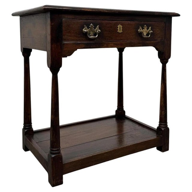 A charming and well-crafted 19th-century English side table, constructed in oak and designed in the Georgian style,...