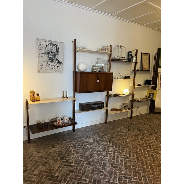 Mid-century wall unit by William Watting for Fristho. This piece features very nice detail elements. The layout is modular...