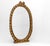 Pair of early 20th century small oval gilt composition wall mirrors. French. Circa 1900. The decorative frames having leaf...