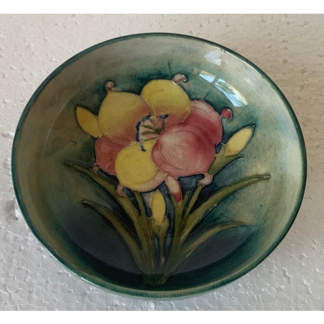 Lilies set against cobalt blue glaze; 4.5” diameter