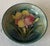 Lilies set against cobalt blue glaze; 4.5” diameter
