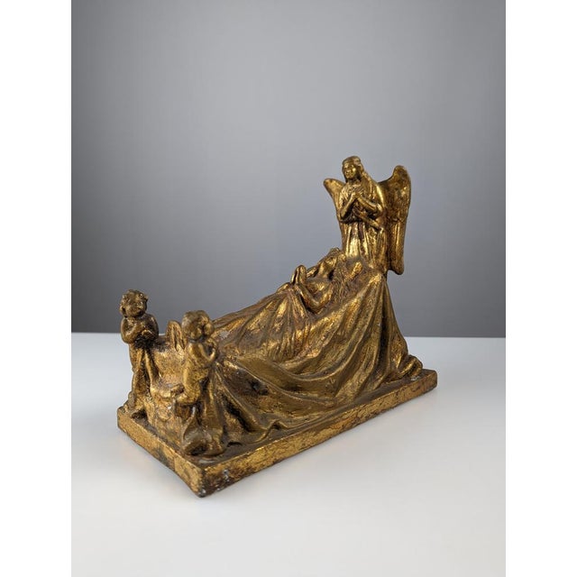 Beautiful sculpture made in terracotta patinated in gold representing a Queen praying accompanied by two cherubs at her...