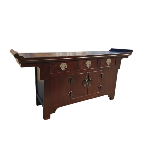 This late 19th century sideboard is crafted from solid elm wood with a rich reddish-brown lacquer finish. The top features...