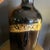 Circa mid 19th century; Large 13” tall, 6” diameter bottom, slightly larger near the top; very dark amber; gold painted...