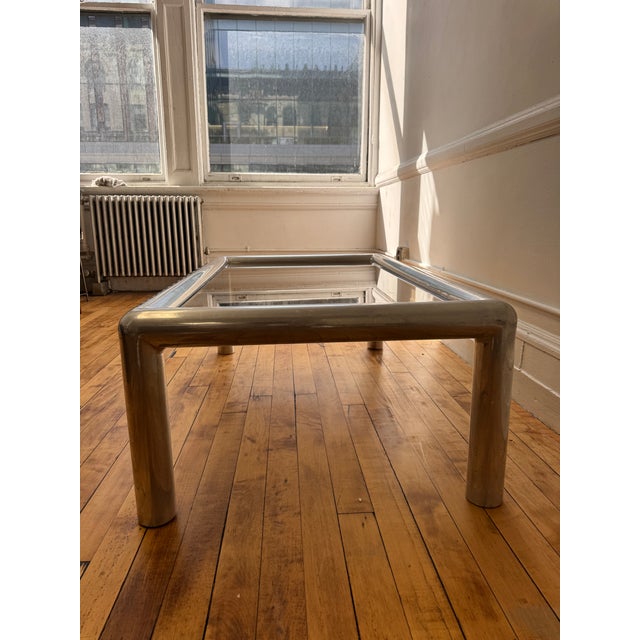 Hand signed and dated John Mascheroni “Tubo” Aluminum Coffee Table with original smoked glass top that rests within the...
