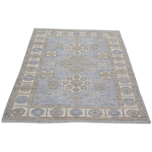 Hand-knotted with care using traditional rug making techniques, this wool rug blends timeless craftsmanship with a modern...