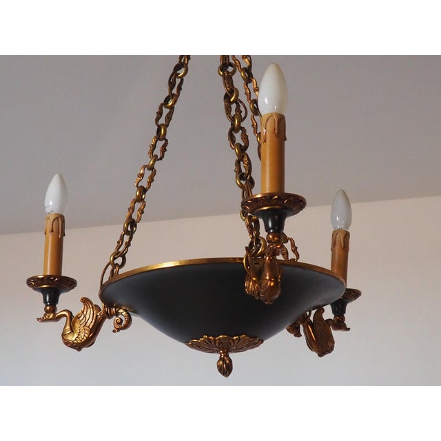 Beautiful 3 arm empire style chandelier crafted in solid bronze with a metal central bowl in dark green, three swan-shaped...