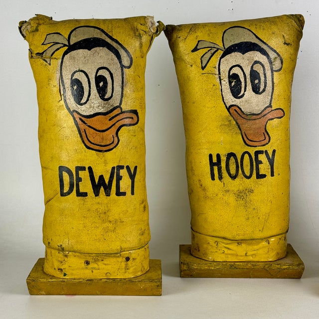A rare set of 3 Mid 20th Century Americana carnival fairground circus knock downs in sunny yellow. They feature Hooey,...
