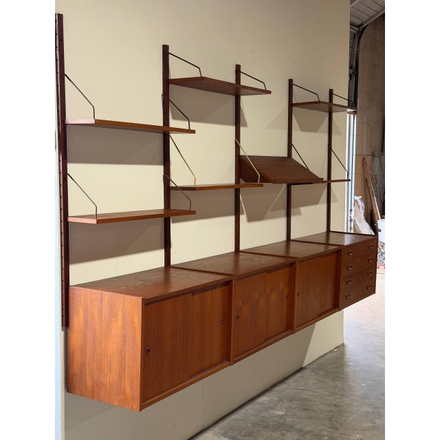 This large modular shelving system features an expansive floating form with rich grain patterns. It offers generous...