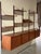 This large modular shelving system features an expansive floating form with rich grain patterns. It offers generous...