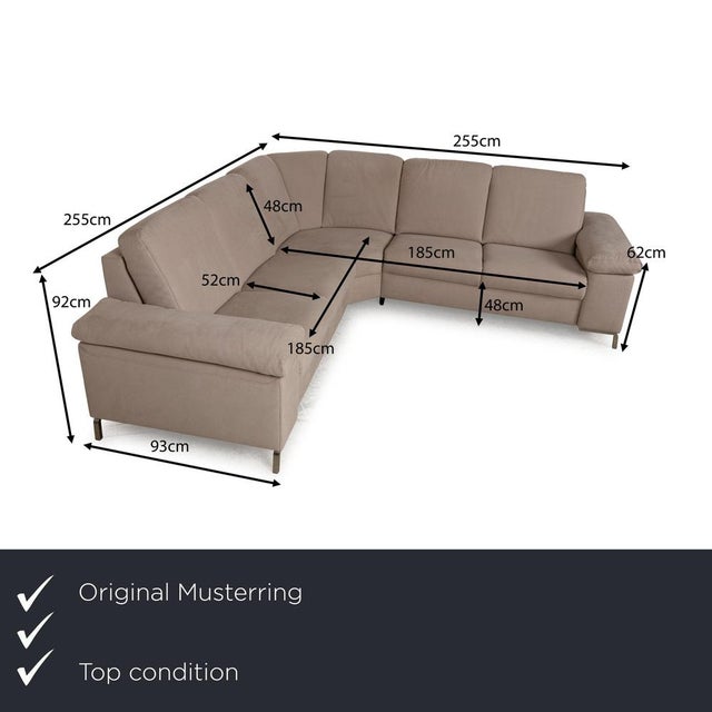 The sofa from Musterring is covered in a beige fabric and stands on narrow metal angles as legs. The corner sofa is...