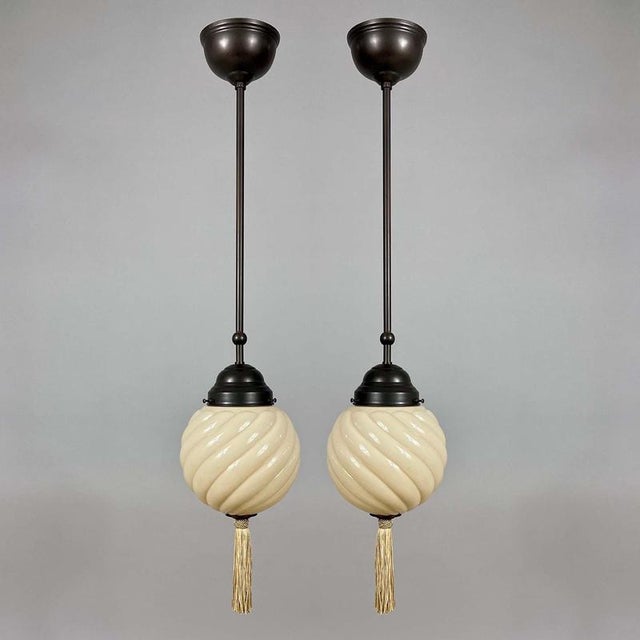 These Art Deco pendants were designed and manufactured in Germany in the 1930s. The lights feature a matching pair of...