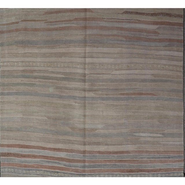 Measures: 3'9 x 6'0 This wonderful piece features easy colors and a simple design. The palette consists of muted reds and...