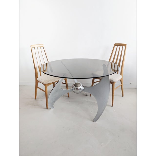 Show-stopping 1970s dining table featuring 3 brushed steel propeller legs, held together by a floating sphere in the...