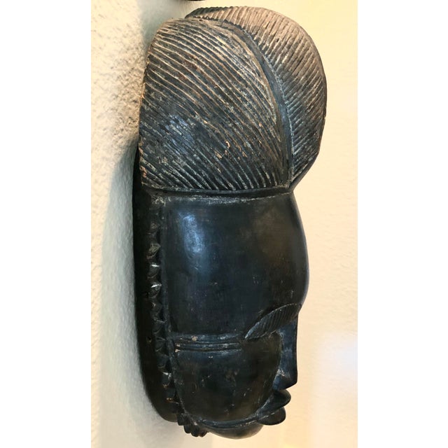 Vintage African Baule Mask This striking mask is a classic example of a Baule portrait mask, known as an ‘Mblo’ or...