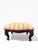 A charming vintage carved wood footstool featuring a richly toned wood frame with graceful cabriole legs and subtle...