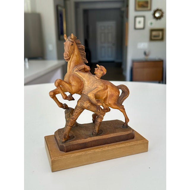 Small scale vintage hand carved wood horse and jockey sculpture made by Anri in Italy. ANRI is a prestigious Italian brand...