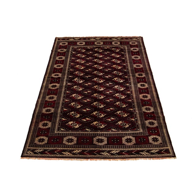 Beautiful vintage Turkman rug with a red-burgundy field. This piece has ivory and blue accents in an all-over geometric...