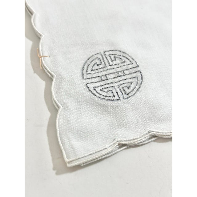 Elegant new old stock cocktail napkins in crisp white cotton with refined silver embroidery, featuring a traditional...