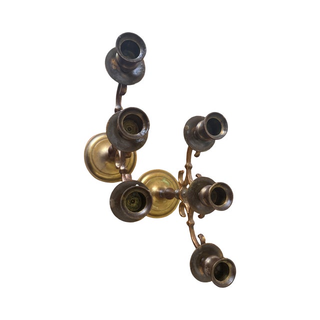 A handsome pair of heavy vintage brass three-light candelabra with timeless proportions and the rich patina collectors and...
