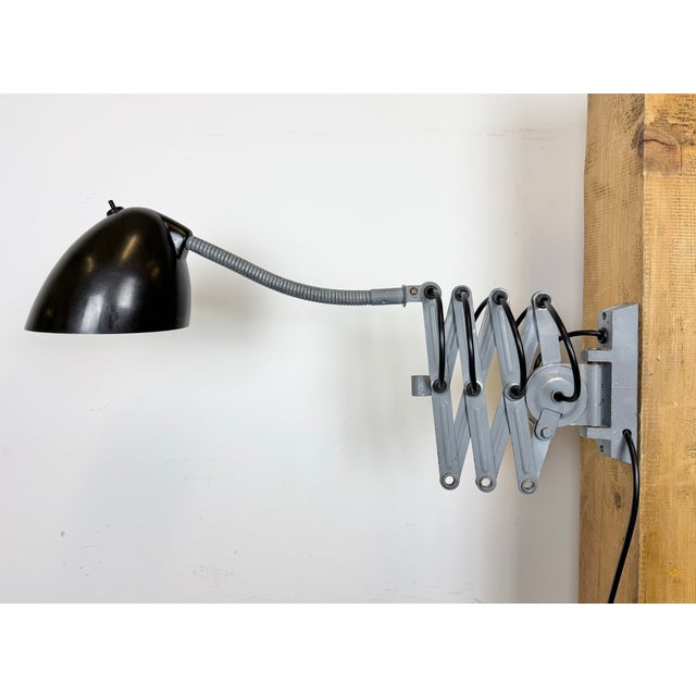 This vintage adjustable gooseneck industrial scissor wall light was produced by elektroinstala in former czechoslovakia...
