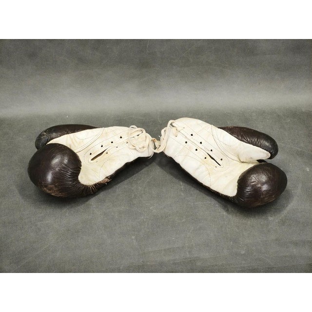 Rare original boxing training set from 1940s Czechoslovakia comprising a pair of leather boxing gloves and a leather...