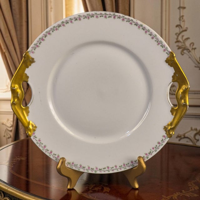 The Limoges L. Bernardaud gilded platter with floral border is a vintage piece of porcelain dinnerware crafted in Limoges,...