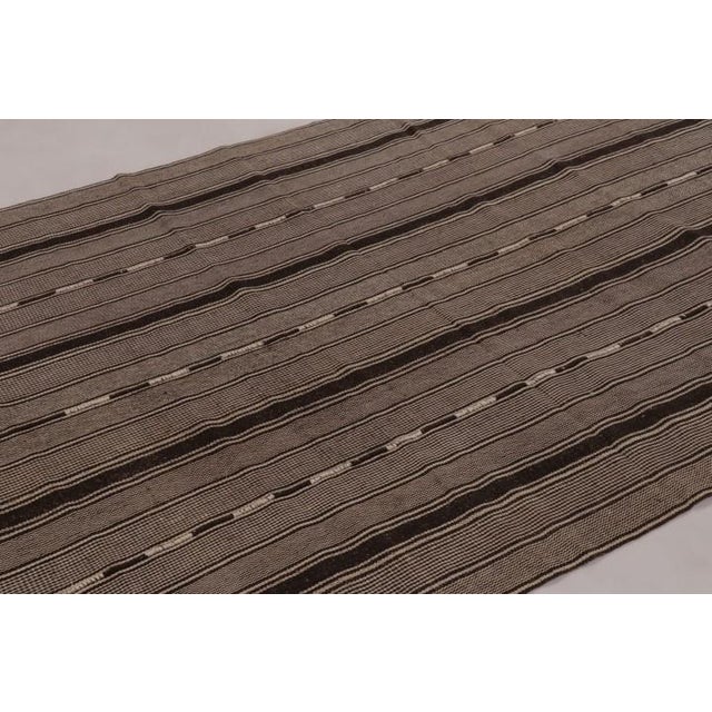 Handwoven in wool and originating circa 1950-1960, this 6x8 vintage Persian kilim is a sophisticated tribal curation among...