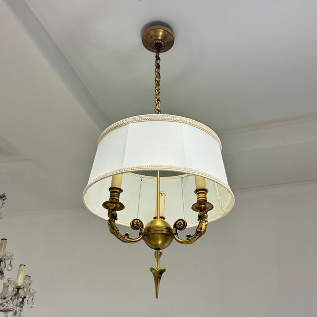 French Empire style gold bronze chandelier, France 1950s. Gold bronze spherical body pierced with an arrow, three arms...