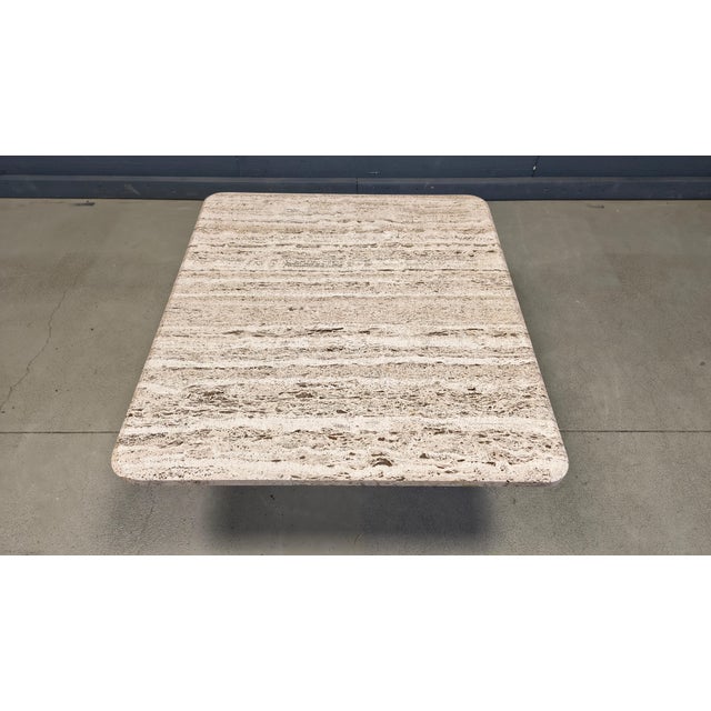 Vintage travertine coffee table or side table from the 1970s. Nicely shaped 'rough' travertine table top The table is in...