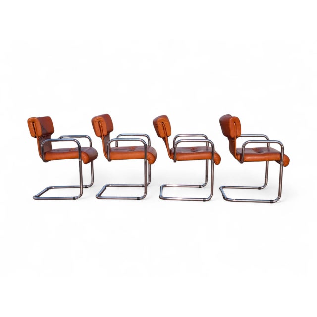 This elegant set of four chairs with armrests is a fine example of Midcentury Modern design, attributed to renowned...