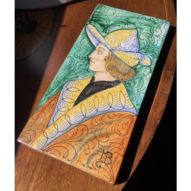 Colorful Italian majolica tile featuring a portrait of a young man. Dimensions: 6” x 11.925” x .925” Rustic European...