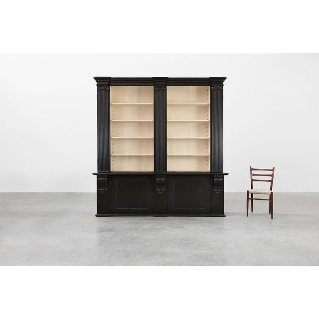 This elegant tall library cabinet from the United Kingdom, crafted in the 20th century, combines classic architectural...