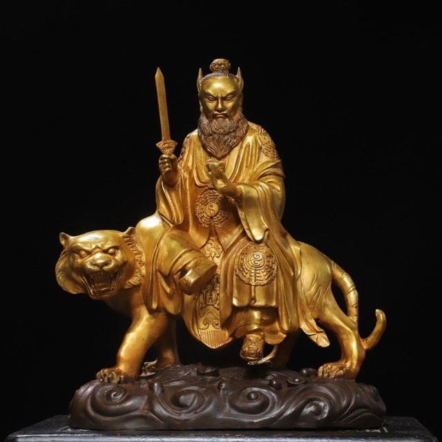 This is a large and impressive antique gilt bronze sculpture depicting Zhang Tianshi, a revered Taoist deity and celestial...
