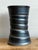 This vintage studio pottery vase is a masterclass in texture and tonal depth, featuring an architectural ribbed form that...