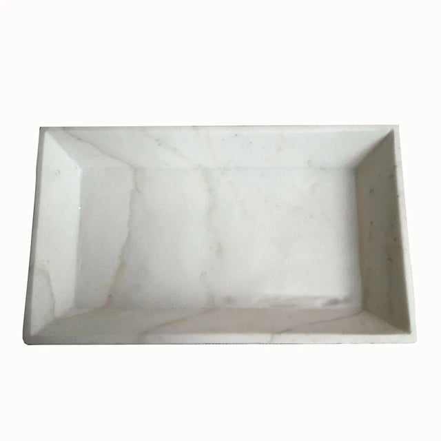A white marble tray from India with beveled sides. Sleek and elegant, this small tray is ideal as an accessories tray for...