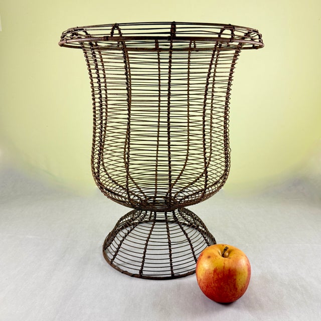 From France, A very large pedestal base, urn form twisted wire standing basket with a wide upper rolled rim, circa...