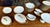 "Limoges 48-piece dinner service" porcelain dinner service with rosette decoration and gilding around the edge of the...