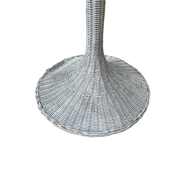 Vintage Mid-Century, Coastal Tulip Table with a white wicker Tulip style base and a round wood trim edge and a white...