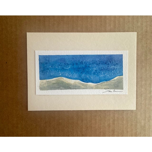 This serene watercolor painting captures the essence calm with soft, muted tones. The composition features gentle, rolling...