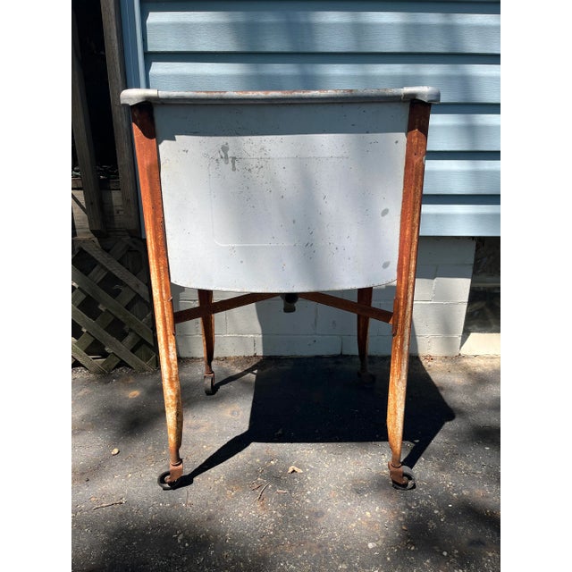 Antique metal one piece wash tub on casters that would make quite the outdoor piece! So many uses possible - planter, ice...
