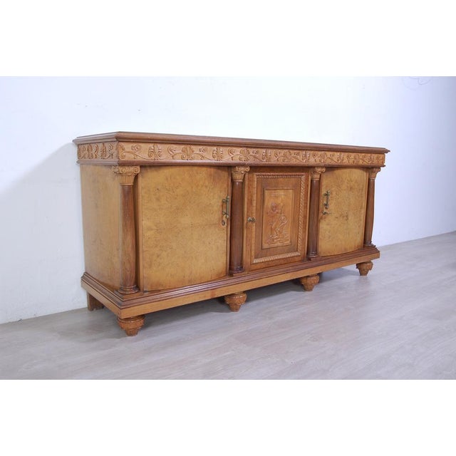 Imposing sideboard with mirror, furniture room Italian production (Milan Brianza) 1940s-1950s; the design takes up the...